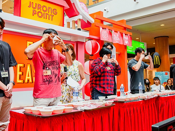Participants slurp their noodles as fast as possible to beat the clock.