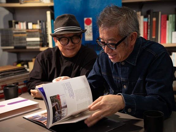 Sandy (right) and Ringo (left) browse through the photo book.