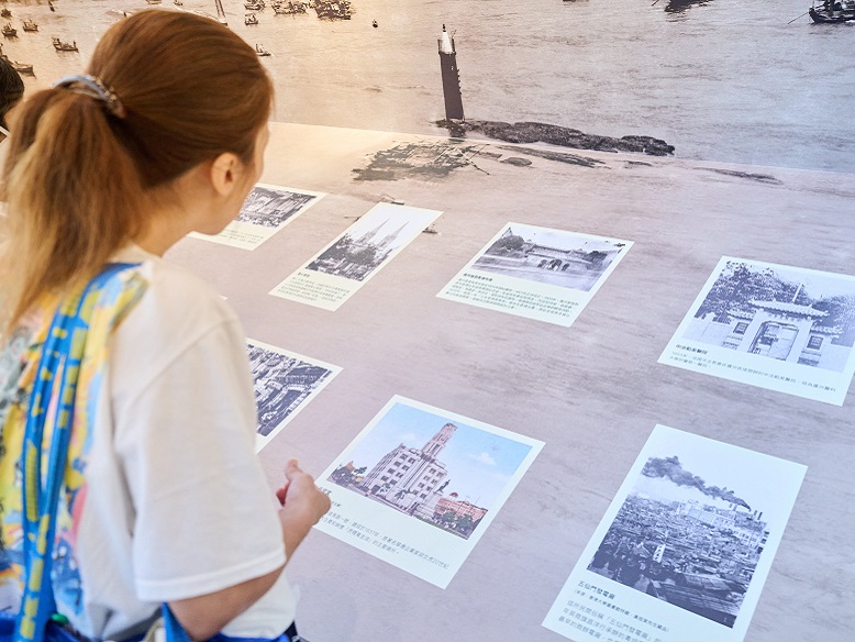 Ms Lam, fully immersed in the exhibition, reads the image descriptions with great interest.