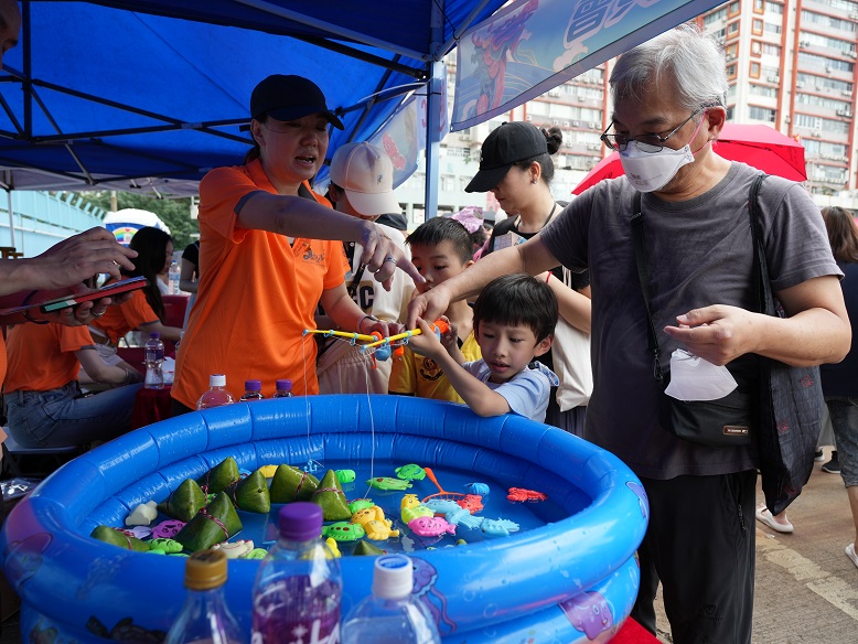 Families come together to play at the game stalls.