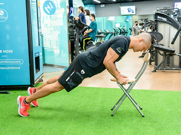 Place both hands on a chair and do push-ups to train chest muscles.