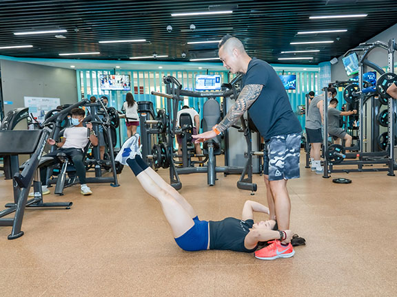 Partner leg raise: one person lies flat and does crunches, raising his/her legs upwards. The partner takes hold of his/her ankles, and then pushes the legs back to the ground, which targets the abdominal muscles.