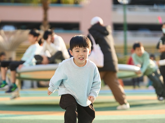 Bau Bau beams with joy as he plays freely on the installations.