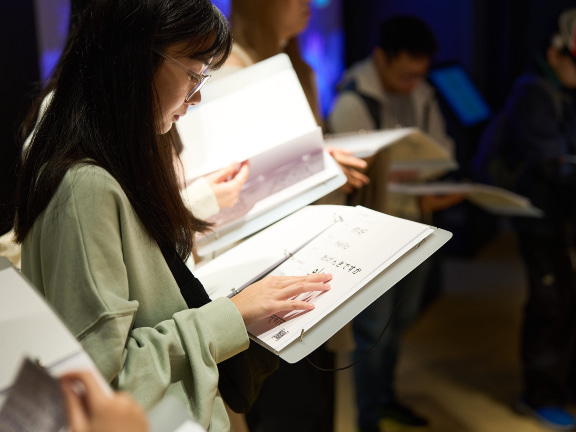 Participants explored tactile graphics with their hands, immersing themselves in the visually impaired experience.