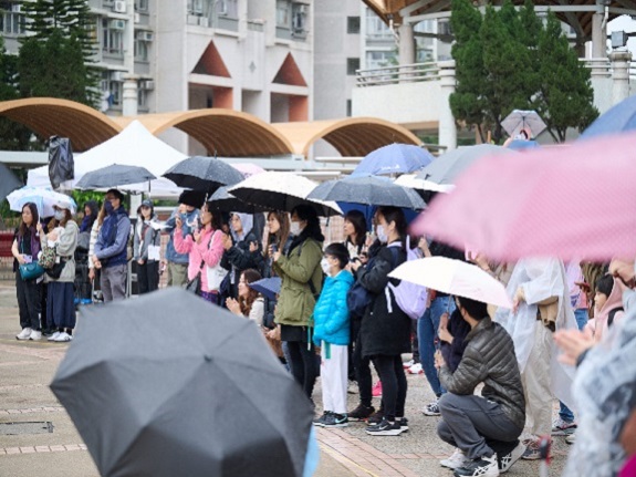 Despite adverse weather conditions, a substantial number of local residents and members of the public braved the wind and rain to enjoy the performance.