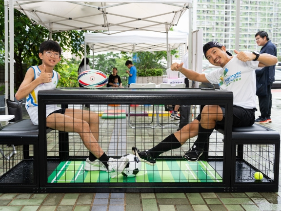 Father and son try out the football game.