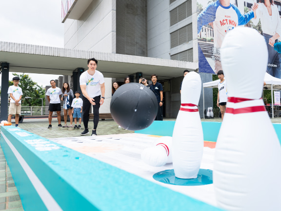 Hong Kong’s “Prince of Still Rings” Kelvin Ng tries out inflatable bowling.