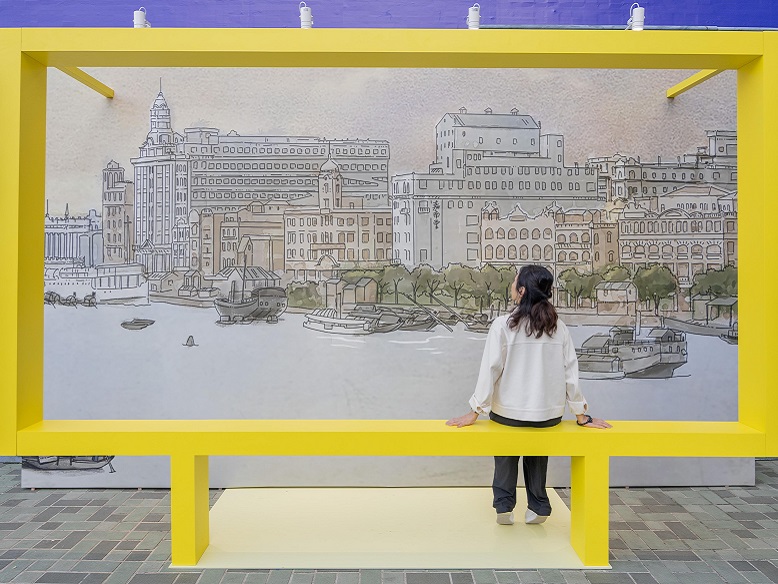 Visitors take pictures in front of the outdoor installation.