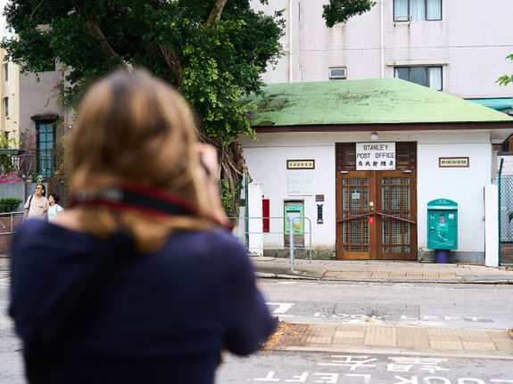 Emily snaps photos of traditional buildings on Hong Kong streets.