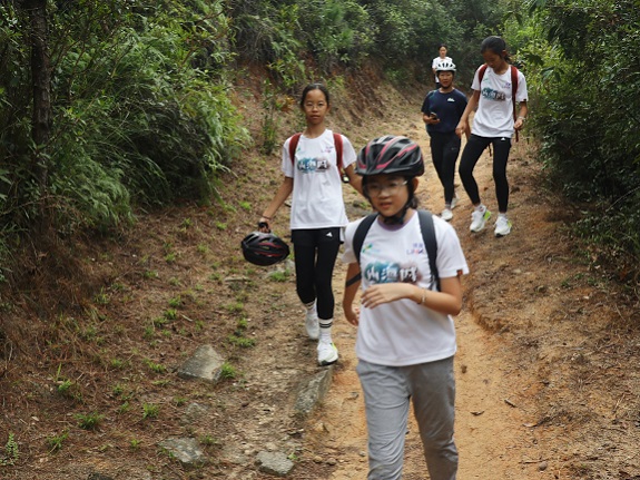 Mountain biking participants learn essential turning and braking techniques under expert guidance.