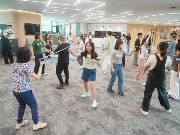 Miya Cheung delights in the “Bamboo Connection” game, learning how physical actions can convey meaning and care.