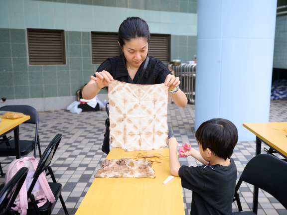 Wendy and son Given at the workshop. Given’s reaction upon seeing his own work? “This is fun!”