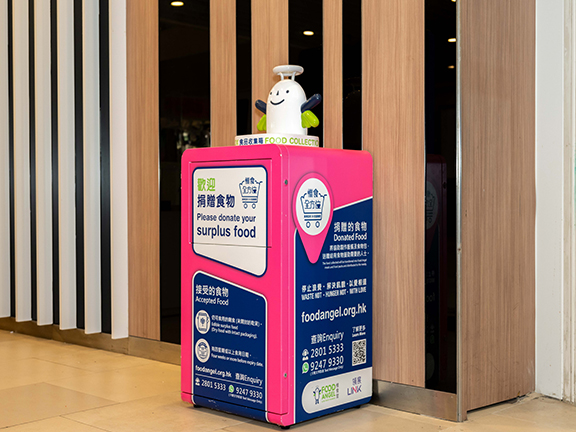 Food collection boxes are set up outside fresh markets for people to donate edible food.
