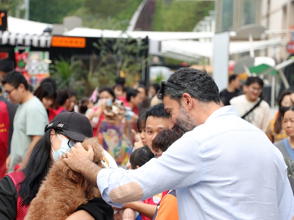Enthusiastic visitors interacting closely with adorable furry friends.
