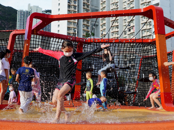 The playground’s splash pad becomes a spot for kids to play and cool off in the summer.