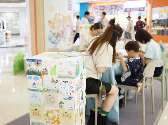 Participants focus on their artwork during a session at Tai Wo Plaza, each engaging at their own pace within the shared community space.